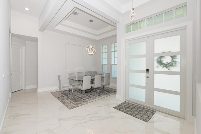 dining area featuring visible vents, baseboards, a tray ceiling, french doors, and marble finish floor