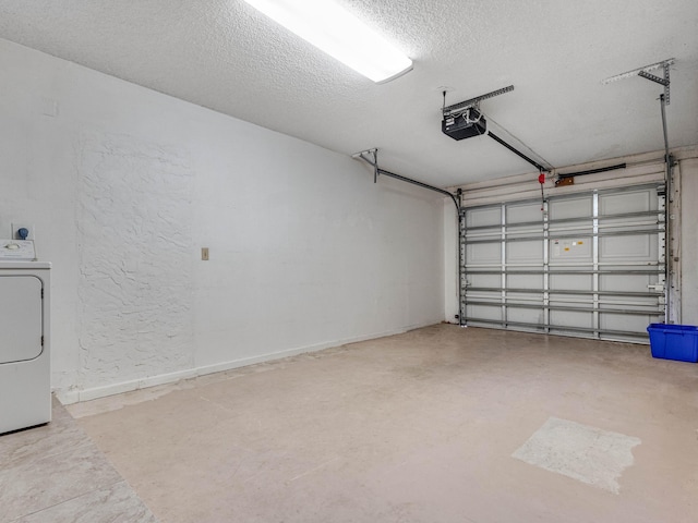 garage featuring a garage door opener and washer / dryer