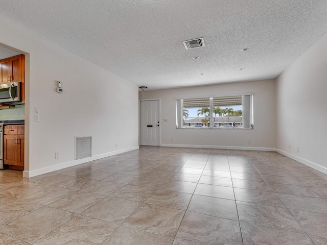 spare room featuring a textured ceiling