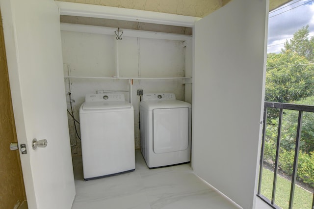 laundry room with a healthy amount of sunlight and washing machine and clothes dryer