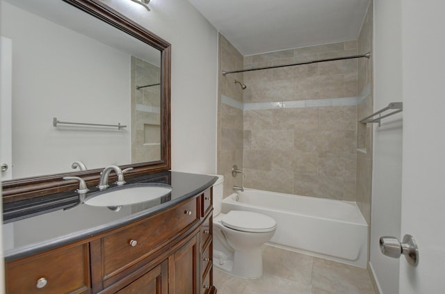 full bathroom with tile patterned floors, tiled shower / bath, vanity, and toilet