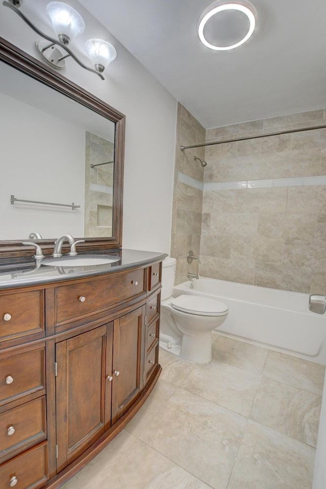 full bathroom with tile patterned floors, vanity, toilet, and tiled shower / bath combo