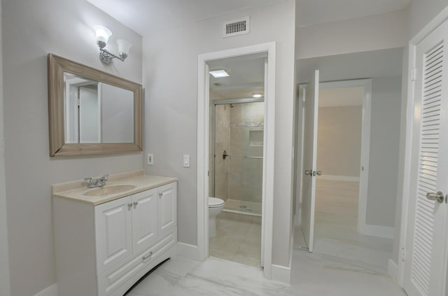 bathroom featuring an enclosed shower, vanity, and toilet