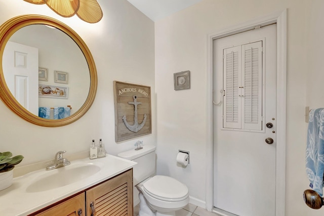 bathroom with tile patterned floors, vanity, and toilet