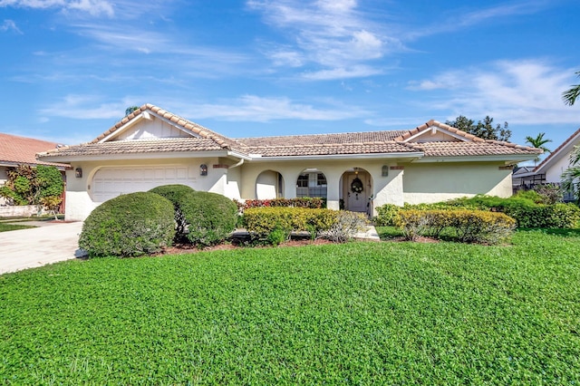 view of front of house with a garage and a front yard