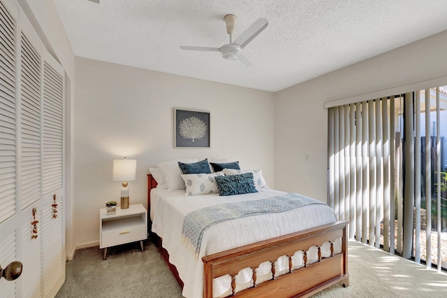 bedroom with ceiling fan, a closet, carpet floors, and a textured ceiling