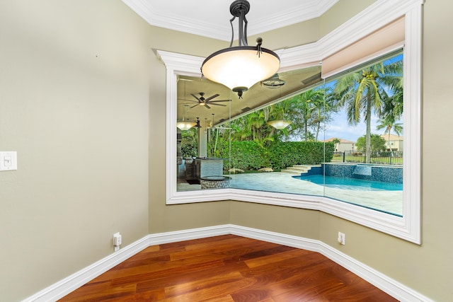 interior space featuring hardwood / wood-style floors, ceiling fan, and crown molding