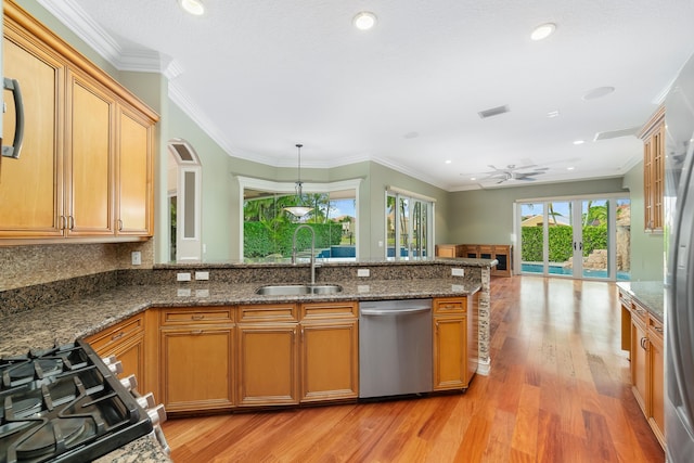 kitchen featuring dishwasher, sink, hanging light fixtures, ceiling fan, and ornamental molding