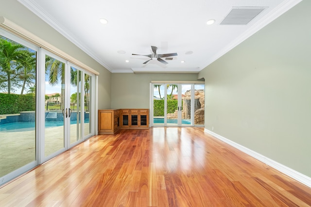 unfurnished living room featuring ceiling fan, light hardwood / wood-style flooring, crown molding, and french doors