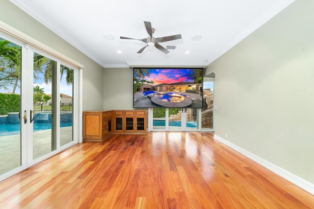 unfurnished living room with french doors, hardwood / wood-style flooring, ceiling fan, and crown molding