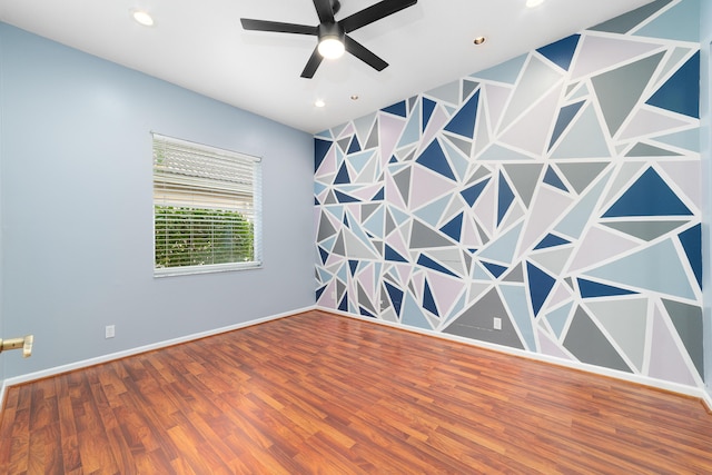 unfurnished room with hardwood / wood-style floors and ceiling fan