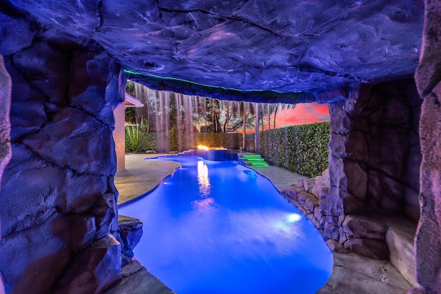 view of pool at dusk