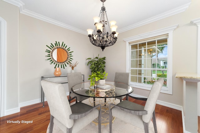 dining room featuring ornamental molding, dark hardwood / wood-style floors, and an inviting chandelier