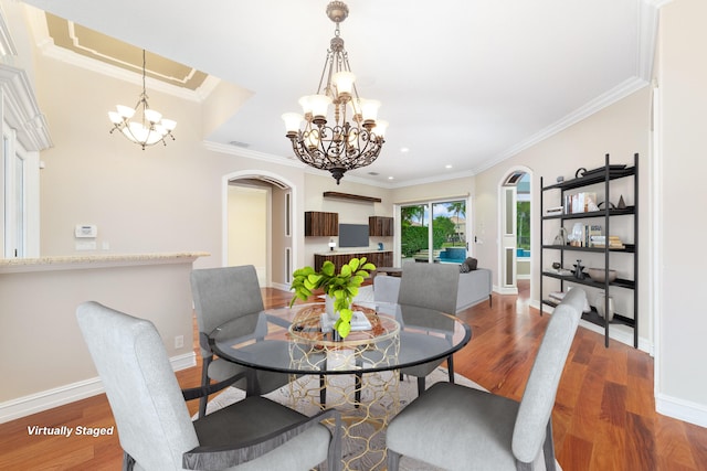 dining space with a chandelier, hardwood / wood-style flooring, and crown molding