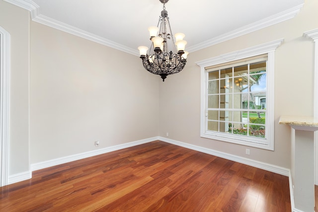 unfurnished dining area featuring hardwood / wood-style floors, ornamental molding, and an inviting chandelier