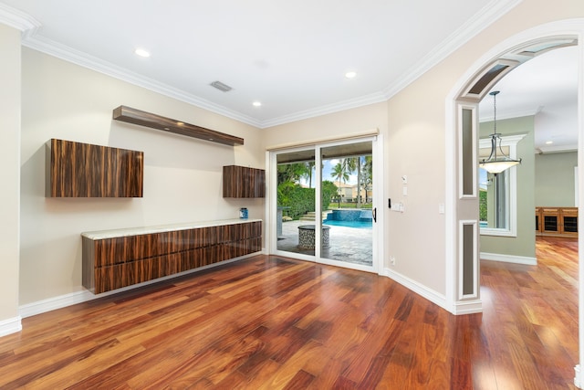 unfurnished room with hardwood / wood-style flooring and ornamental molding