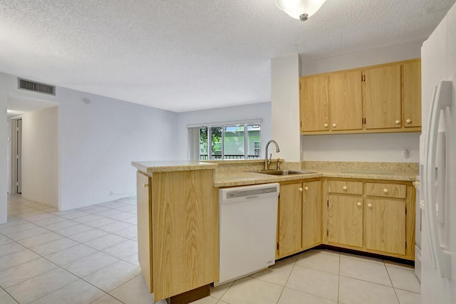 kitchen with a textured ceiling, kitchen peninsula, sink, and white appliances