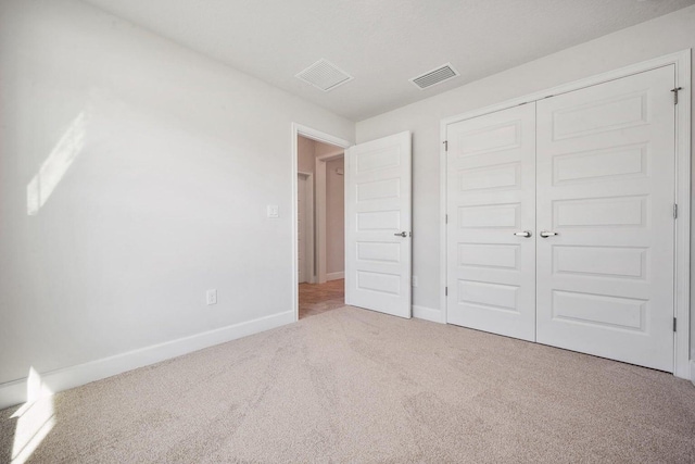 unfurnished bedroom with carpet flooring and a closet