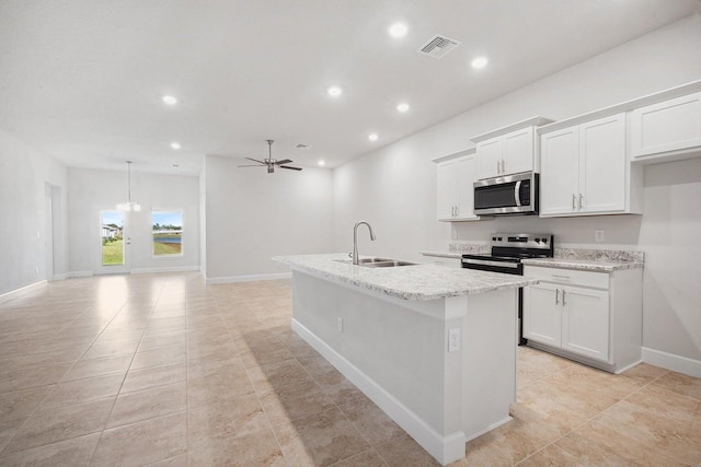 kitchen featuring ceiling fan, sink, a kitchen island with sink, white cabinets, and appliances with stainless steel finishes