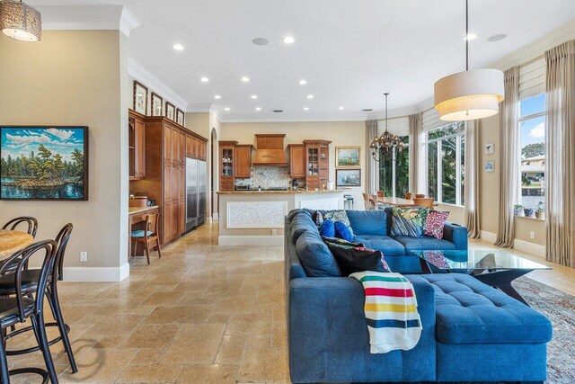 791 NE Marine Dr, Boca Raton, FL 33431 - living room with recessed lighting, ornamental molding, baseboards, and stone tile flooring
