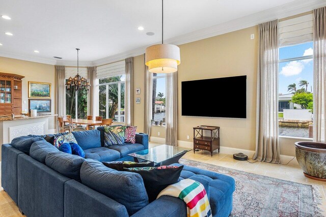 791 NE Marine Dr, Boca Raton, FL 33431 - tiled living room featuring a chandelier, recessed lighting, crown molding, and baseboards