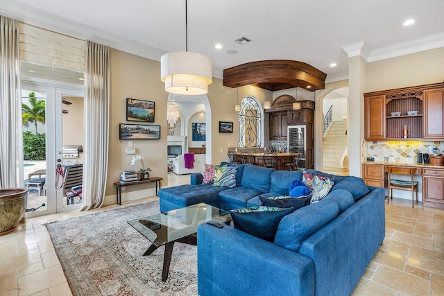 791 NE Marine Dr, Boca Raton, FL 33431 - living room with arched walkways, stone tile floors, crown molding, and recessed lighting