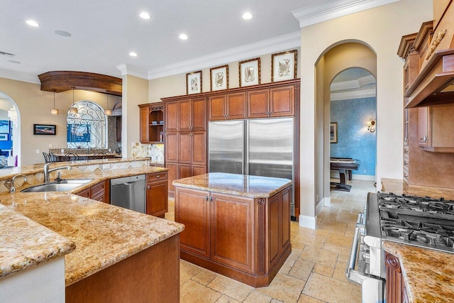 791 NE Marine Dr, Boca Raton, FL 33431 - kitchen featuring arched walkways, stainless steel appliances, stone tile floors, ornamental molding, and a large island with sink