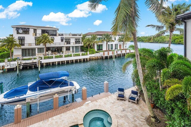 791 NE Marine Dr, Boca Raton, FL 33431 - dock area featuring boat lift, a water view, and an in-ground hot tub