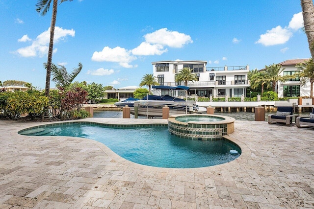 view of swimming pool with a patio area and an in ground hot tub