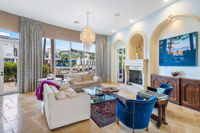 791 NE Marine Dr, Boca Raton, FL 33431 - living room featuring recessed lighting, a chandelier, stone tile flooring, and a fireplace with raised hearth