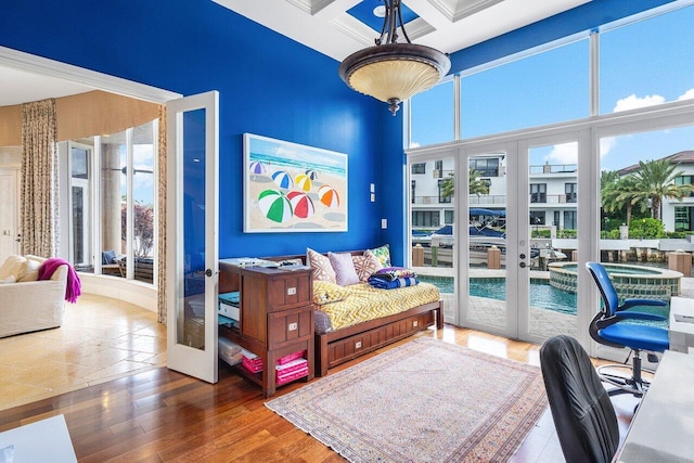 bedroom with coffered ceiling, dark wood-type flooring, beamed ceiling, and french doors