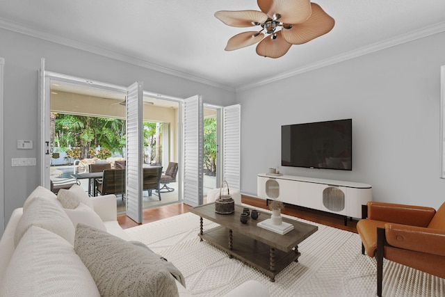 living room with ceiling fan, ornamental molding, and hardwood / wood-style floors