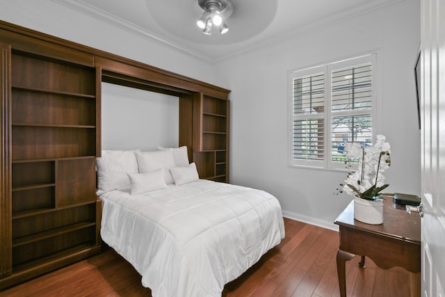 bedroom featuring ornamental molding, dark hardwood / wood-style floors, and ceiling fan