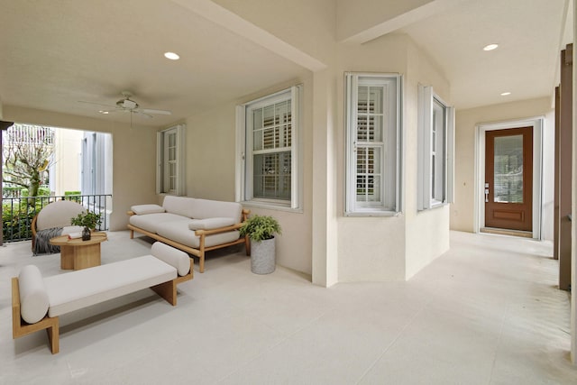 view of patio with an outdoor living space and ceiling fan