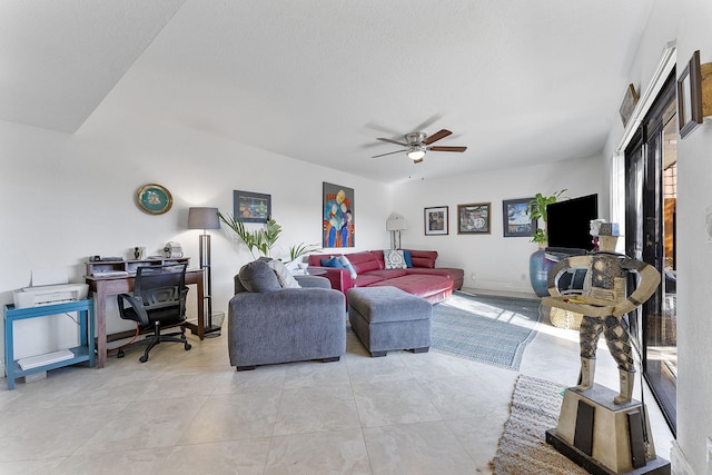 tiled living room featuring ceiling fan and a textured ceiling