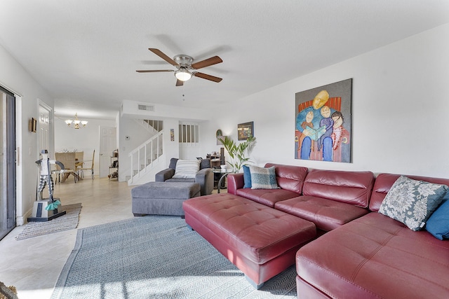 living room featuring ceiling fan with notable chandelier