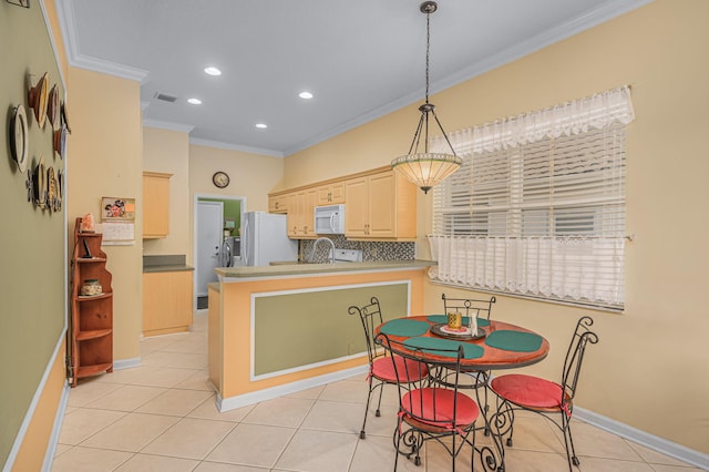 kitchen featuring light brown cabinets, white appliances, decorative light fixtures, and ornamental molding