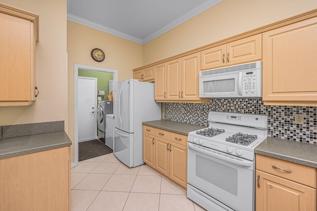 kitchen featuring washing machine and dryer, white appliances, ornamental molding, and light brown cabinetry