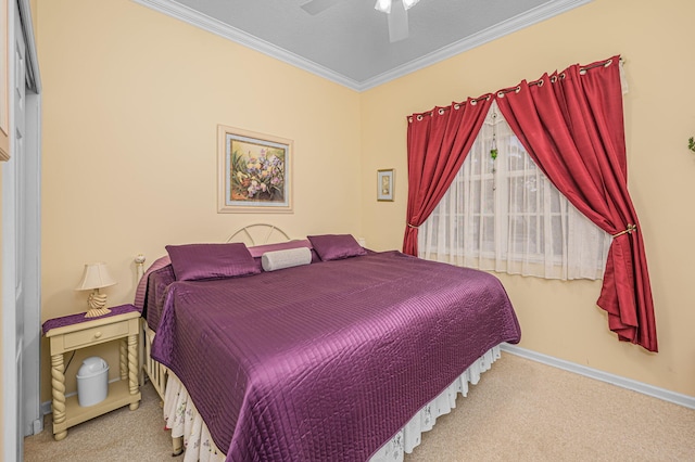 carpeted bedroom featuring ceiling fan and crown molding