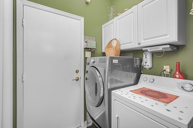 washroom featuring cabinets and separate washer and dryer