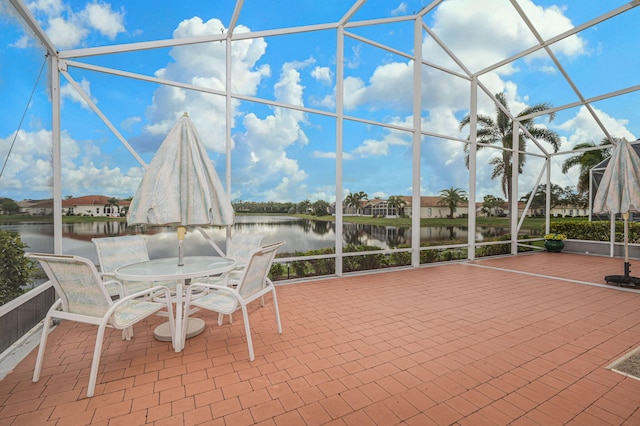 unfurnished sunroom with a water view