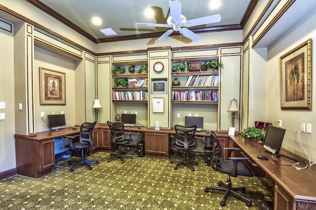 office with ceiling fan, built in desk, carpet floors, and crown molding