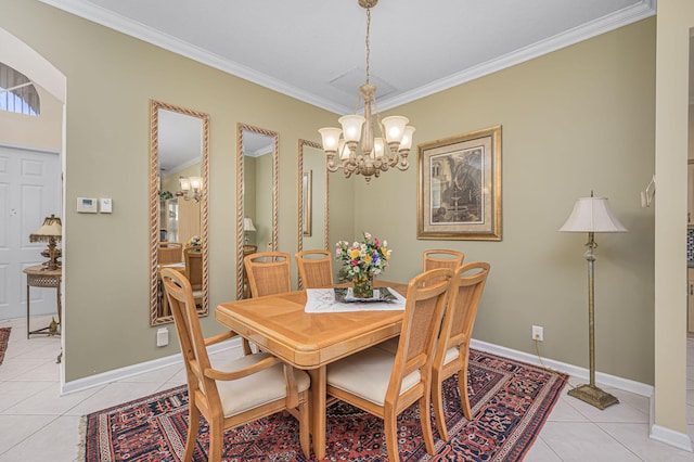 dining area featuring light tile patterned flooring, crown molding, and an inviting chandelier