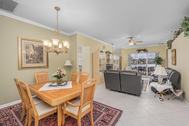 tiled dining area featuring crown molding and ceiling fan with notable chandelier