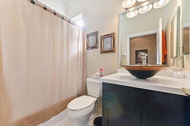 bathroom with toilet, vanity, tile patterned flooring, and curtained shower