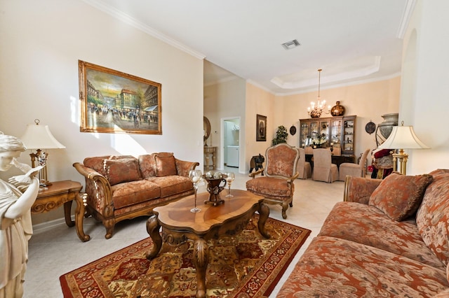 living room featuring a tray ceiling, crown molding, and a notable chandelier