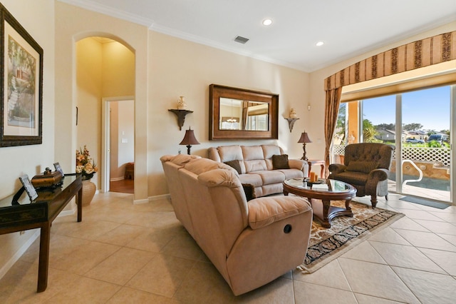 living room with light tile patterned flooring and crown molding