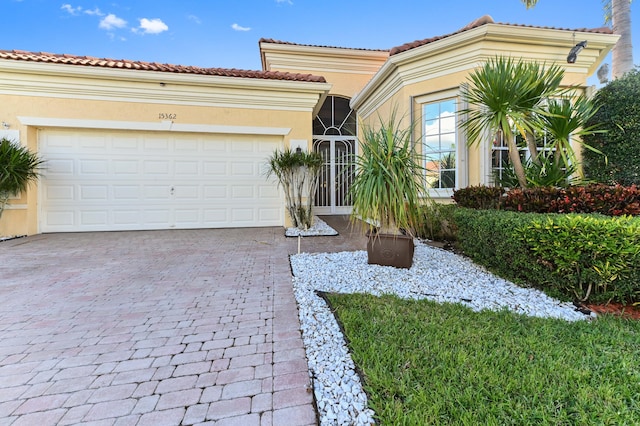 mediterranean / spanish-style home with a garage