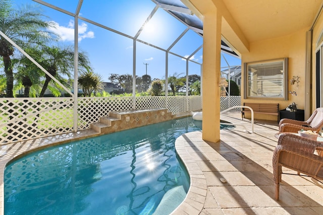 view of pool with a patio and a lanai