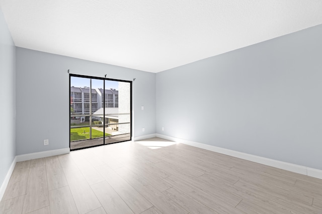 spare room with light wood-type flooring